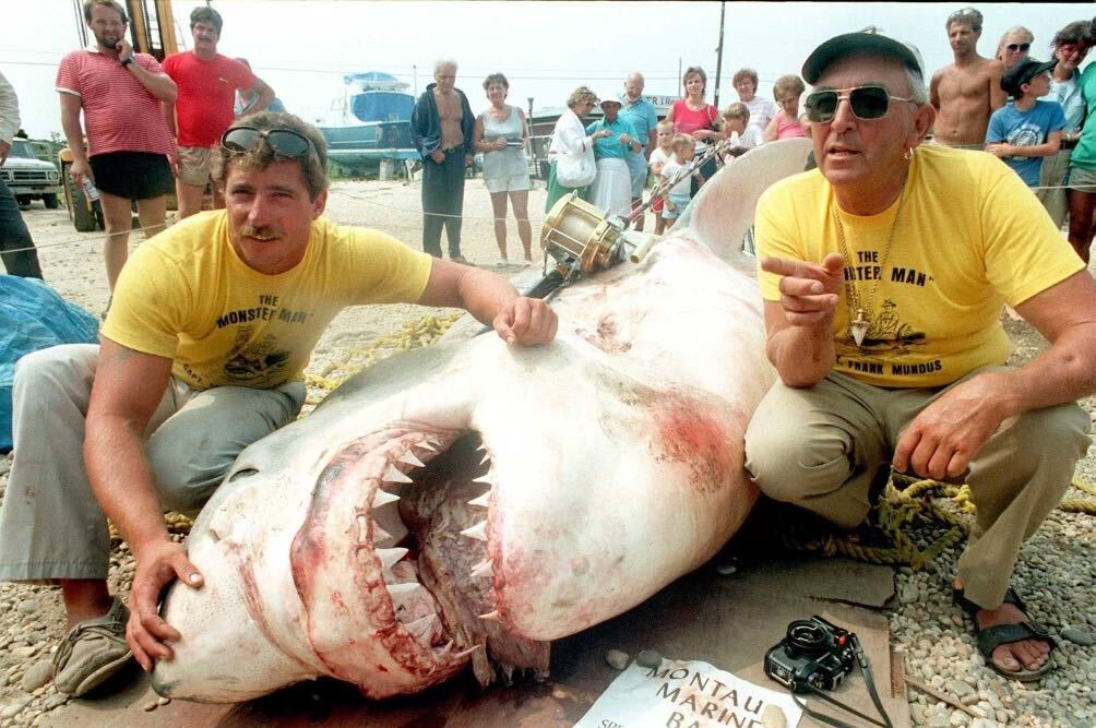 Frank Mundus, the inspiration for Captain Quint in *Jaws*, posing with a large great white shark.