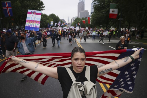 Demonstrators march down Benjamin Franklin Parkway during the