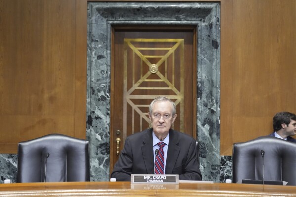 Committee Chairman Sen. Mike Crapo, R-Idaho, arrives and is seated before Secretary of Health and Human Services Robert F. Kennedy Jr., arrives to appear before the Senate Finance Committee, on Capitol Hill in Washington, Thursday, Sept. 4, 2025. (AP Photo/Mark Schiefelbein)