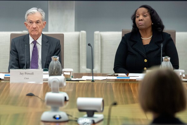 Federal Reserve Chairman Jerome Powell, and Board of Governors member Lisa Cook, right, listen during an open meeting of the Board of Governors at the Federal Reserve, June 25, 2025, in Washington. (AP Photo/Mark Schiefelbein, File)