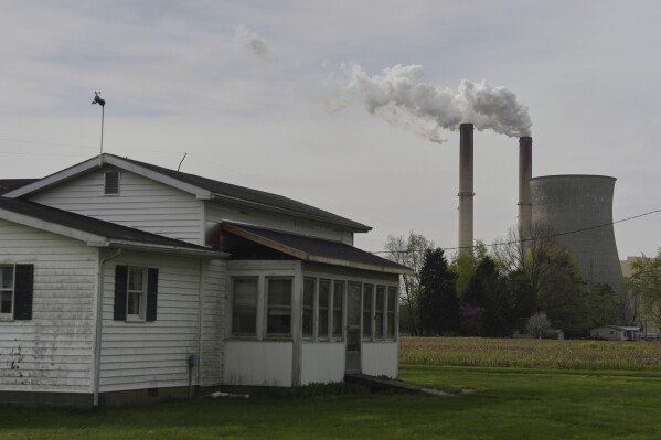 A home sits near the Gen. James Gavin Power Plant, a coal-fired power plant, April 14, 2025, in Cheshire, Ohio. (AP Photo/Joshua A. Bickel, File)