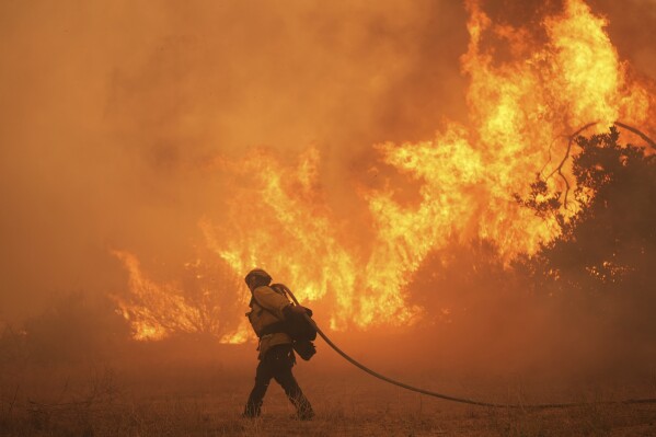 A firefighter battles the Canyon Fire on Aug. 7, 2025, in Hasley Canyon, Calif. (AP Photo/Marcio Jose Sanchez, File)